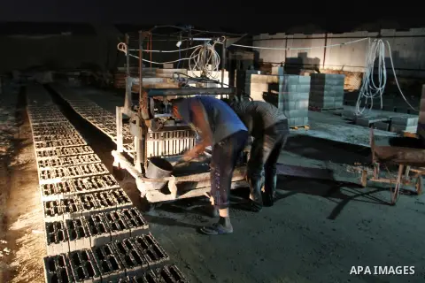 Palestinian labourers work at a cement factory at night to avoid the day time heat in Rafah in the southern Gaza Strip on June 22, 2016 during Islam's holy fasting month of Ramadan. Ramadan is sacred to Muslims because i...