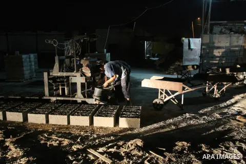 Palestinian labourers work at a cement factory at night to avoid the day time heat in Rafah in the southern Gaza Strip on June 22, 2016 during Islam's holy fasting month of Ramadan. Ramadan is sacred to Muslims because i...