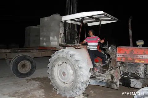 Palestinian labourers work at a cement factory at night to avoid the day time heat in Rafah in the southern Gaza Strip on June 22, 2016 during Islam's holy fasting month of Ramadan. Ramadan is sacred to Muslims because i...