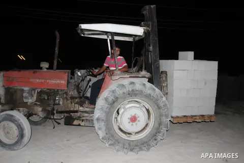 Palestinian labourers work at a cement factory at night to avoid the day time heat in Rafah in the southern Gaza Strip on June 22, 2016 during Islam's holy fasting month of Ramadan. Ramadan is sacred to Muslims because i...