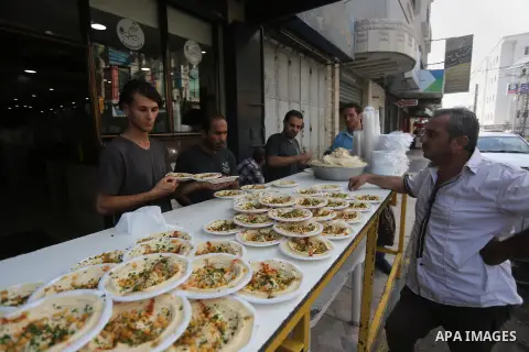Palestinians prepare chickpeas known as hummus for breakfasting during the holy fasting month of Ramadan in Gaza city, on June 23, 2016. Muslims around the world refrain from eating, drinking and sexual intercourse from...