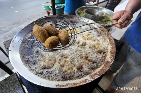 Palestinians prepare chickpeas known as Falafel for breakfasting during the holy fasting month of Ramadan in Gaza city, on June 23, 2016. Muslims around the world refrain from eating, drinking and sexual intercourse from...