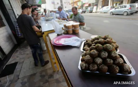 Palestinians prepare chickpeas known as Falafel for breakfasting during the holy fasting month of Ramadan in Gaza city, on June 23, 2016. Muslims around the world refrain from eating, drinking and sexual intercourse from...