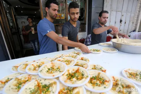 Palestinians prepare chickpeas known as hummus for breakfasting during the holy fasting month of Ramadan in Gaza city, on June 23, 2016. Muslims around the world refrain from eating, drinking and sexual intercourse from...