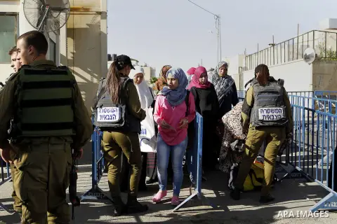 Palestinians walk through an Israeli checkpoint as they make their way to attend the third Friday prayer of the holy fasting month of Ramadan in Jerusalem's al-Aqsa mosque, in the West bank city of Bethlehem June 24, 201...