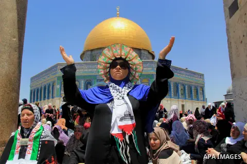 Palestinian Muslim worshippers perform Friday prayer in front of the Dome of the Rock mosque at the al-Aqsa mosque compound in Jerusalem's old city on June 24, 2016 during the holy fasting month of Ramadan. Photo by Mahf...