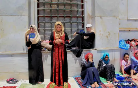 Palestinian Muslim worshippers perform Friday prayer in front of the Dome of the Rock mosque at the al-Aqsa mosque compound in Jerusalem's old city on June 24, 2016 during the holy fasting month of Ramadan. Photo by Mahf...