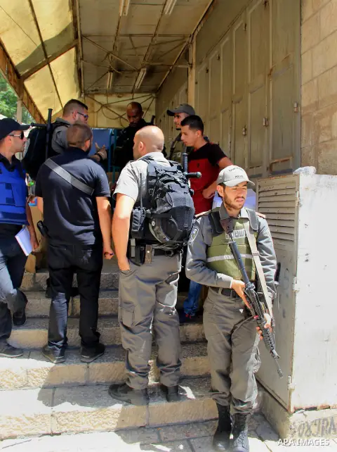 Israeli border police stand guard while Palestinians pray in at Jerusalem's Al-Asqa mosque compound in Jerusalem's old city on June 24, 2016 during the holy fasting month of Ramadan. Photo by Mahfouz Abu Turk