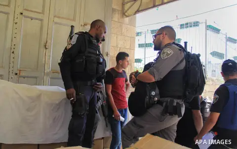 Israeli border police stand guard while Palestinians pray in at Jerusalem's Al-Asqa mosque compound in Jerusalem's old city on June 24, 2016 during the holy fasting month of Ramadan. Photo by Mahfouz Abu Turk