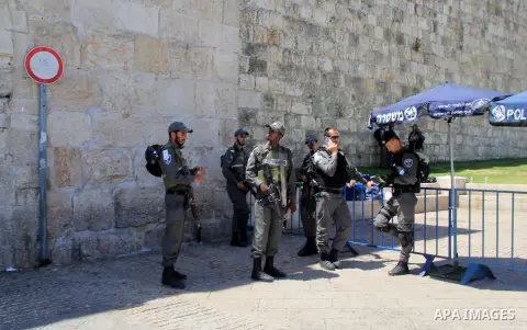 Israeli border police stand guard while Palestinians pray in at Jerusalem's Al-Asqa mosque compound in Jerusalem's old city on June 24, 2016 during the holy fasting month of Ramadan. Photo by Mahfouz Abu Turk