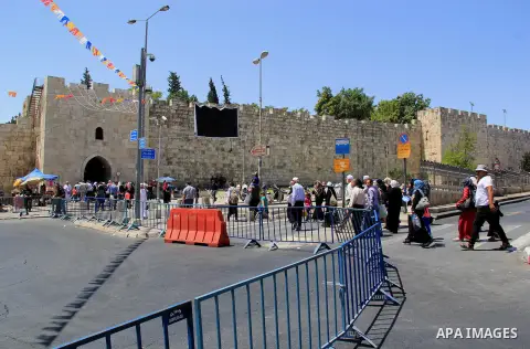 Palestinian men spray water on children to cool them down before prayers on the third Friday of the holy month of Ramadan near the Dome of the Rock, on the compound known to Muslims as Noble Sanctuary and to Jews as Temp...