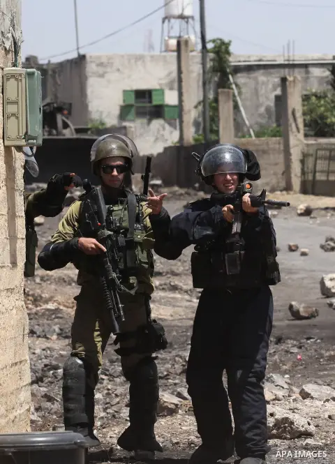Israeli security forces advance during clashes with Palestinian protesters following a demonstration against the expropriation of Palestinian land by Israel on June 24, 2016 in the village of Kfar Qaddum, near Nablus, in...