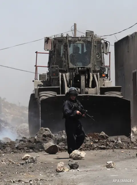 Israeli security forces advance during clashes with Palestinian protesters following a demonstration against the expropriation of Palestinian land by Israel on June 24, 2016 in the village of Kfar Qaddum, near Nablus, in...