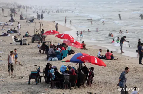 Palestinian muslims prepare to break their fast on the holy fasting month of Ramadan at the beach of the Mediterranean sea on the coast of Gaza city during a hot day, on June 24, 2016. Ramadan is sacred to Muslims becaus...