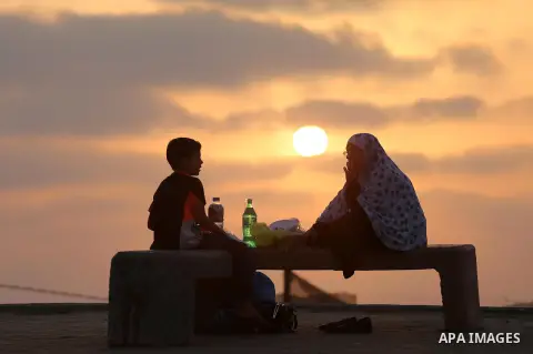 Palestinian muslims prepare to break their fast on the holy fasting month of Ramadan at the beach of the Mediterranean sea on the coast of Gaza city during a hot day, on June 24, 2016. Ramadan is sacred to Muslims becaus...