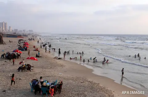 Palestinian muslims prepare to break their fast on the holy fasting month of Ramadan at the beach of the Mediterranean sea on the coast of Gaza city during a hot day, on June 24, 2016. Ramadan is sacred to Muslims becaus...