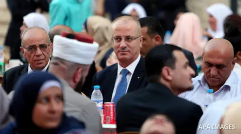 Palestinian Prime Minister Rami Hamdallah takes part during take breakfast for orphans on holy fasting month of Ramadan, at An-Najah national University, in the West Bank City of Nablus, on June 24, 2016. Photo by Prime...