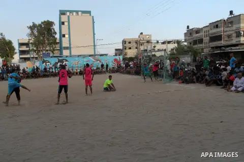 Palestinian youths play football match, at a refugee camp in Rafah, in the southern Gaza Strip, during the Muslim holy month of Ramadan on June 25, 2016. Muslims around the world abstain from food, drink and sexual inter...