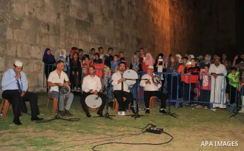 Palestinians attend a ceremony in front of Damascus gate in Jerusalem's old city during the holy fasting month of Ramadan on June 25, 2016. Ramadan is sacred to Muslims because it is during that month that tradition says...