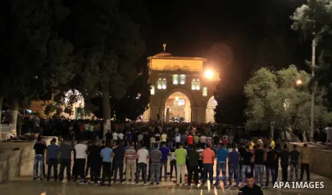Palestinian Muslim worshippers perform "Taraweeh", nightly prayer of the month of Ramadan, in front of the Dome of the Rock mosque, in Jerusalem's old city on June 25, 2016. Ramadan is sacred to Muslims because it is dur...