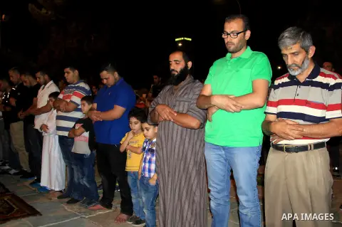 Palestinian Muslim worshippers perform "Taraweeh", nightly prayer of the month of Ramadan, in front of the Dome of the Rock mosque, in Jerusalem's old city on June 25, 2016. Ramadan is sacred to Muslims because it is dur...