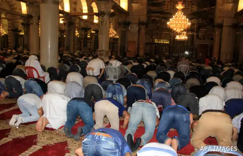 Palestinian Muslim worshippers perform "Taraweeh", nightly prayer of the month of Ramadan, in front of the Dome of the Rock mosque, in Jerusalem's old city on June 25, 2016. Ramadan is sacred to Muslims because it is dur...
