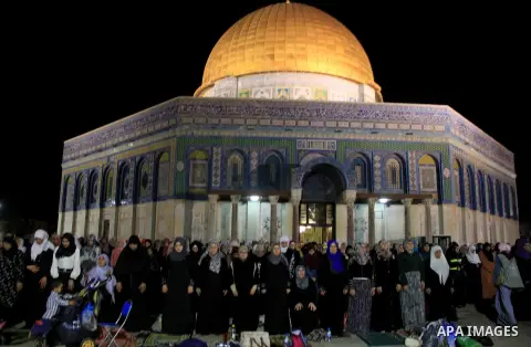 Palestinian Muslim worshippers perform "Taraweeh", nightly prayer of the month of Ramadan, in front of the Dome of the Rock mosque, in Jerusalem's old city on June 25, 2016. Ramadan is sacred to Muslims because it is dur...