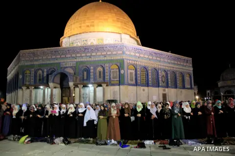 Palestinian Muslim worshippers perform "Taraweeh", nightly prayer of the month of Ramadan, in front of the Dome of the Rock mosque, in Jerusalem's old city on June 25, 2016. Ramadan is sacred to Muslims because it is dur...