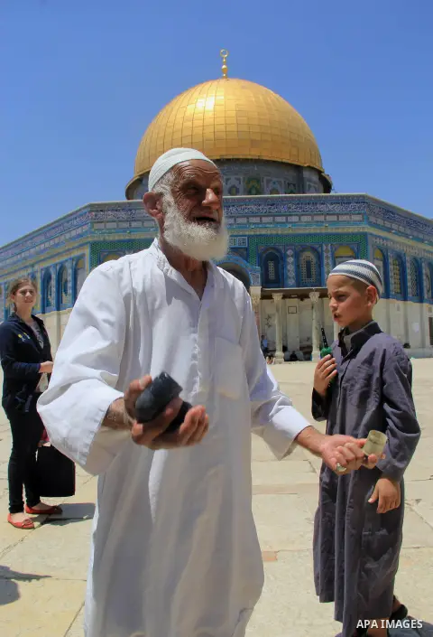 A Palestinian man shows foam-tipped bullets reportedly used by Israeli riot police outside the Dome of the Rock in Jerusalem's Al-Aqsa mosque compound after clashes erupted at the compound between Palestinians and Israel...