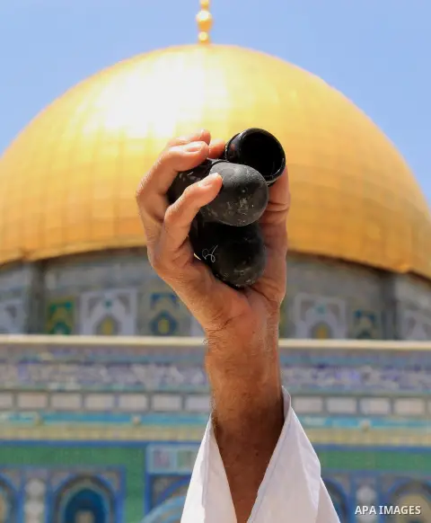 A Palestinian man shows foam-tipped bullets reportedly used by Israeli riot police outside the Dome of the Rock in Jerusalem's Al-Aqsa mosque compound after clashes erupted at the compound between Palestinians and Israel...