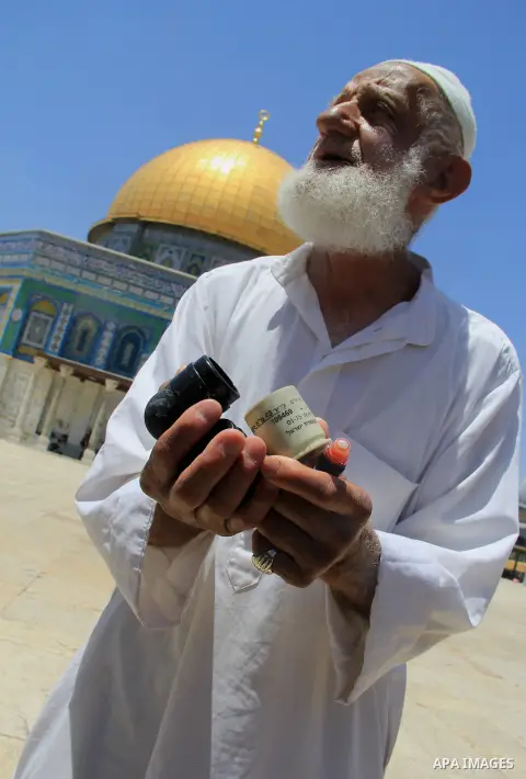 A Palestinian man shows foam-tipped bullets reportedly used by Israeli riot police outside the Dome of the Rock in Jerusalem's Al-Aqsa mosque compound after clashes erupted at the compound between Palestinians and Israel...