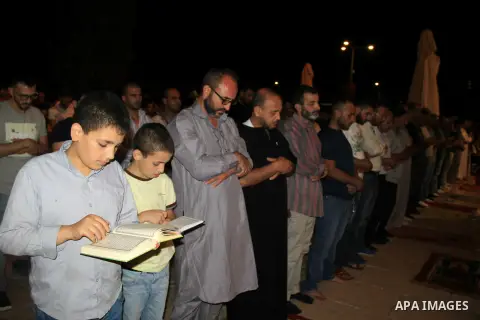 Palestinian Muslim worshippers perform "Taraweeh", nightly prayer of the month of Ramadan, in front of the Dome of the Rock mosque, in Jerusalem's old city on June 26, 2016. Ramadan is sacred to Muslims because it is dur...