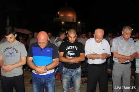 Palestinian Muslim worshippers perform "Taraweeh", nightly prayer of the month of Ramadan, in front of the Dome of the Rock mosque, in Jerusalem's old city on June 26, 2016. Ramadan is sacred to Muslims because it is dur...