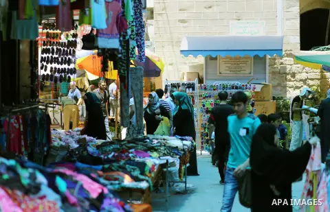 Palestinians shop at clothes market during the Muslim holy month of Ramadan, in Gaza city on June 27, 2016. Ramadan is sacred to Muslims because it is during that month that tradition says the Koran was revealed to the P...