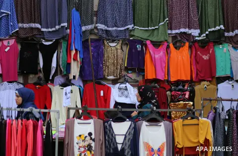 Palestinians shop at clothes market during the Muslim holy month of Ramadan, in Gaza city on June 27, 2016. Ramadan is sacred to Muslims because it is during that month that tradition says the Koran was revealed to the P...
