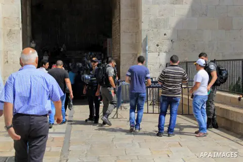 Palestinian men walk outside Jerusalem's al-Aqsa mosque after clashes erupted at the compound between Palestinians and Israeli police, on June 28, 2016. An Israeli police spokesman said on Tuesday that the compound would...