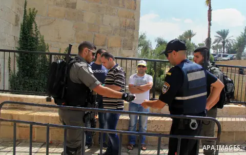Israeli policemen checks the IDs of Palestinian youths at Al-Aqsa Mosque compound in Jerusalem's old city, on June 28, 2016. An Israeli police spokesman said on Tuesday that the compound would be closed to visitors, incl...