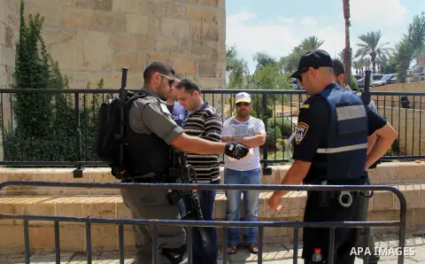 Israeli policemen checks the IDs of Palestinian youths at Al-Aqsa Mosque compound in Jerusalem's old city, on June 28, 2016. An Israeli police spokesman said on Tuesday that the compound would be closed to visitors, incl...