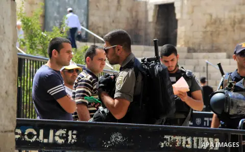 Israeli policemen checks the IDs of Palestinian youths at Al-Aqsa Mosque compound in Jerusalem's old city, on June 28, 2016. An Israeli police spokesman said on Tuesday that the compound would be closed to visitors, incl...