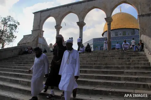 Palestinian men walk outside Jerusalem's al-Aqsa mosque after clashes erupted at the compound between Palestinians and Israeli police, on June 28, 2016. An Israeli police spokesman said on Tuesday that the compound would...