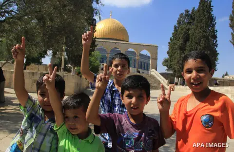 Palestinian children play during the holy month of Ramadan, in front of the Dome of the Rock mosque at the al-Aqsa mosque compound, in Jerusalem's old city, on June 28, 2016. An Israeli police spokesman said on Tuesday t...