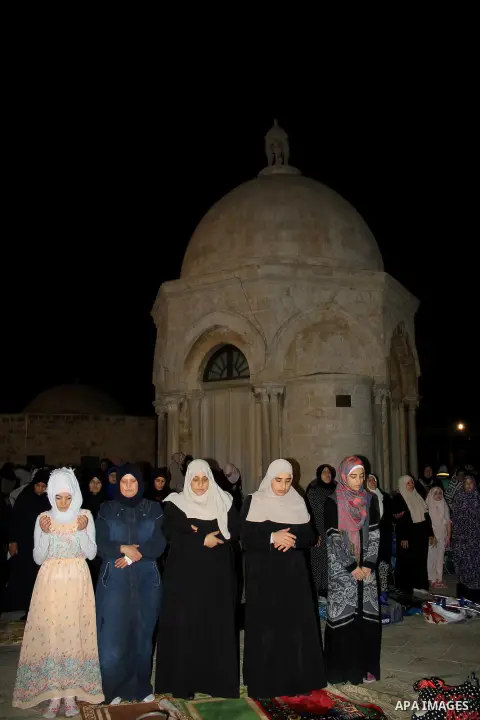 Palestinian Muslim worshippers perform "Taraweeh", nightly prayer of the month of Ramadan, in front of the Dome of the Rock mosque, in Jerusalem's old city on June 28, 2016. Ramadan is sacred to Muslims because it is dur...