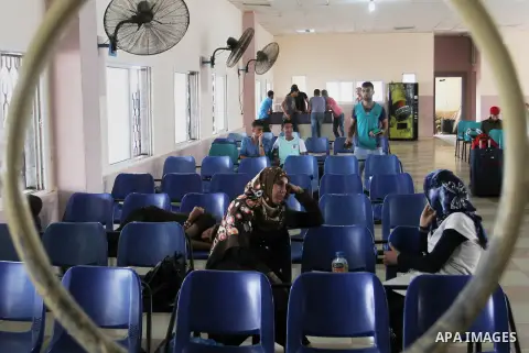 Palestinians wait for a travel permit to cross into Egypt through the Rafah border crossing after it was opened by Egyptian authorities for five days, in the southern Gaza Strip June 29, 2016. Photo by Abed Rahim Khatib