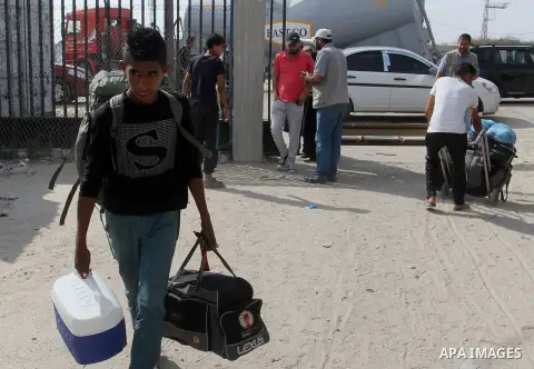 Palestinians pull their luggage as they wait for a travel permit to cross into Egypt through the Rafah border crossing after it was opened by Egyptian authorities for five days, in the southern Gaza Strip June 29, 2016....