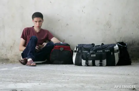 A Palestinian man waits for a travel permit to cross into Egypt through the Rafah border crossing after it was opened by Egyptian authorities for five days, in the southern Gaza Strip June 29, 2016. Photo by Abed Rahim K...