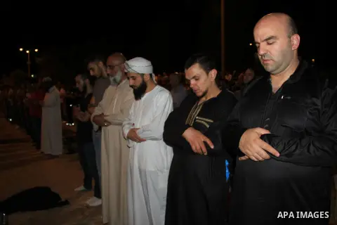 Palestinian Muslim worshippers perform "Taraweeh", nightly prayer of the month of Ramadan, in front of the Dome of the Rock mosque, in Jerusalem's old city on June 29, 2016. Ramadan is sacred to Muslims because it is dur...
