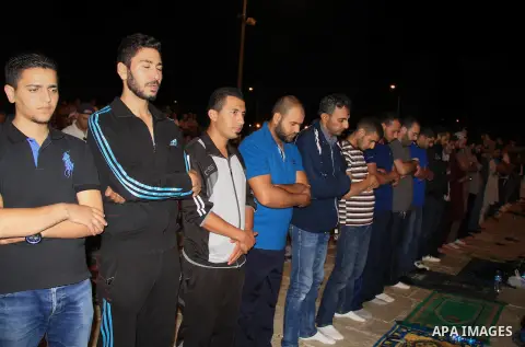 Palestinian Muslim worshippers perform "Taraweeh", nightly prayer of the month of Ramadan, in front of the Dome of the Rock mosque, in Jerusalem's old city on June 29, 2016. Ramadan is sacred to Muslims because it is dur...