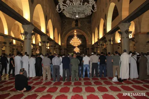 Palestinian Muslim worshippers perform "Taraweeh", nightly prayer of the month of Ramadan, in front of the Dome of the Rock mosque, in Jerusalem's old city on June 29, 2016. Ramadan is sacred to Muslims because it is dur...