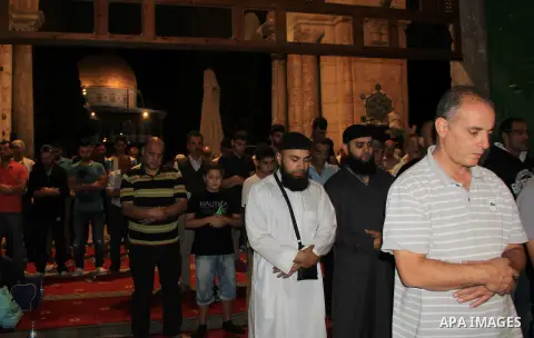 Palestinian Muslim worshippers perform "Taraweeh", nightly prayer of the month of Ramadan, in front of the Dome of the Rock mosque, in Jerusalem's old city on June 29, 2016. Ramadan is sacred to Muslims because it is dur...