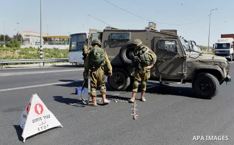 Israeli security forces gather near the scene of what the Israeli military said was an attack by Palestinian in the Jewish settlement of Kiryat Arba near the West Bank city of Hebron 30 June 2016. Israeli army said the P...